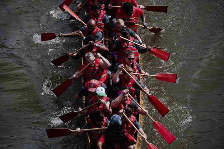 Racers from the Ohio State University Wexner Medical Center paddle down the Scioto River while competing during the Columbus Asian Festival Dragon Boat Races at West Bank Park in Columbus.   (Joshua A. Bickel / The Columbus Dispatch)